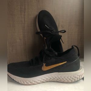 Nike React. Black and gold lace up.